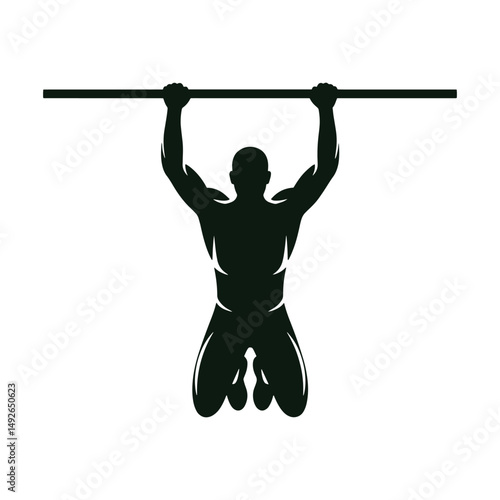 Silhouette of a Man Performing a Pull-Up Exercise in Gym