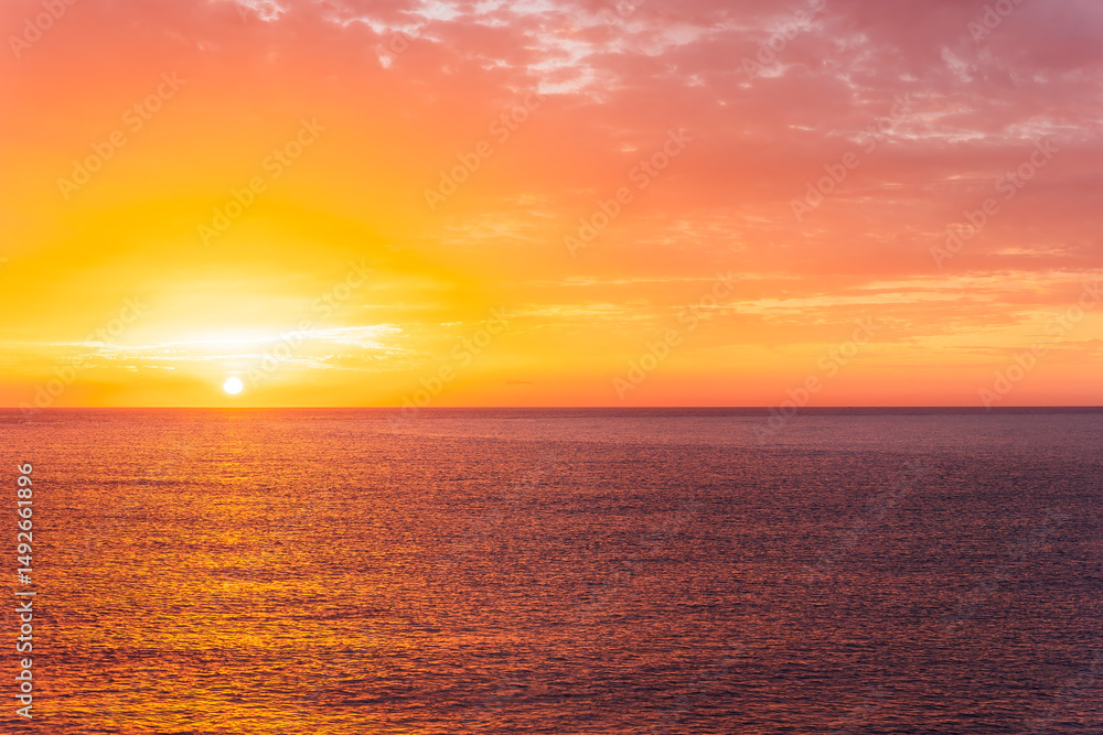 Fototapeta premium beautiful sunrise or sunset seascape with amazing calm sea water with waves and colorful amazing cloudy morning sky on background