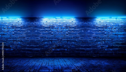 blue neon light on a brick wall at night