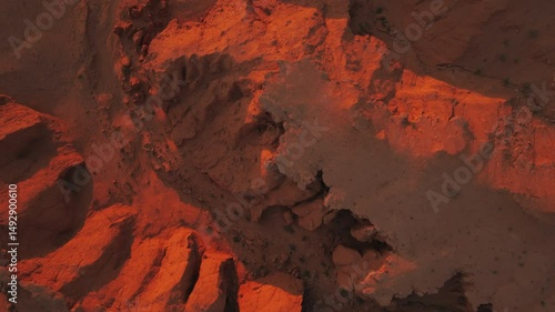 Aerial drone views of the Flaming Cliffs at sunset, exploring Mongolia’s stunning red rock formations