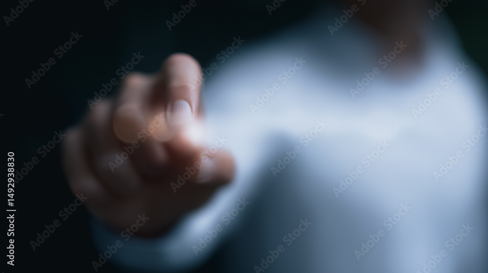 Obraz premium Navigating the Future: Focused hand reaching toward a blurry backdrop. This evocative image, captured from a close-up perspective, presents a hand, the focal point, reaching out.
