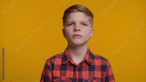 Boy Shaking Head Saying 'No No No' on Yellow Background