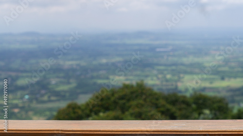 Wallpaper Mural Brown wooden table empty for product presentation related to nature, with blurred background of trees and flat area below, seen from a high angle. Torontodigital.ca