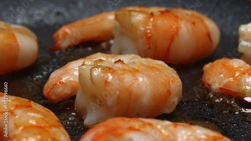 Raw Peeled Shrimp Frying in Hot Skillet Pan.
