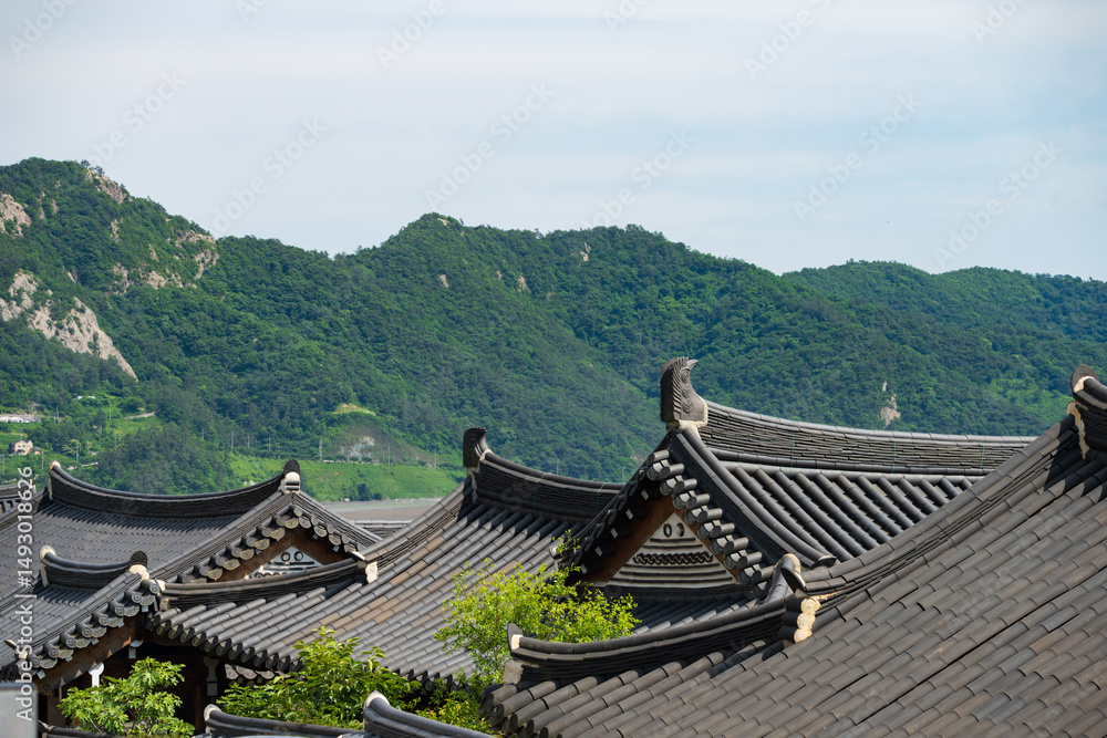 Traditional Korean Hanok Roofs with Mountain Backdrop