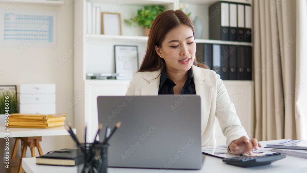 Professional businesswoman reviewing reports and working on budget planning. Professional businesswoman reviewing reports and working on budget planning.