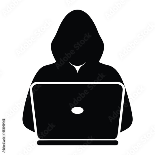 Anonymous hacker in a hoodie using a laptop for cybercrime activity