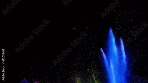 vibrant fountain of colors exploding against a dark background