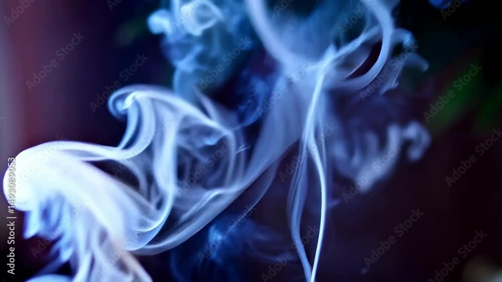 Abstract blue smoke swirls against a dark background, creating flowing, ethereal, and hypnotic patterns with blurred edges, movement and texture. Abstract blue smoke swirls against a dark background, creating flowing, ethereal, and hypnotic patterns with blurred edges, movement and texture.