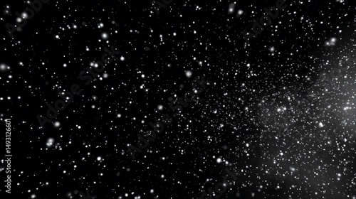 Falling snow on a black background.  A flurry of tiny, bright white particles, like snowflakes, moving diagonally across the image