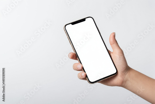 A person is holding a cell phone with a blank or white screen