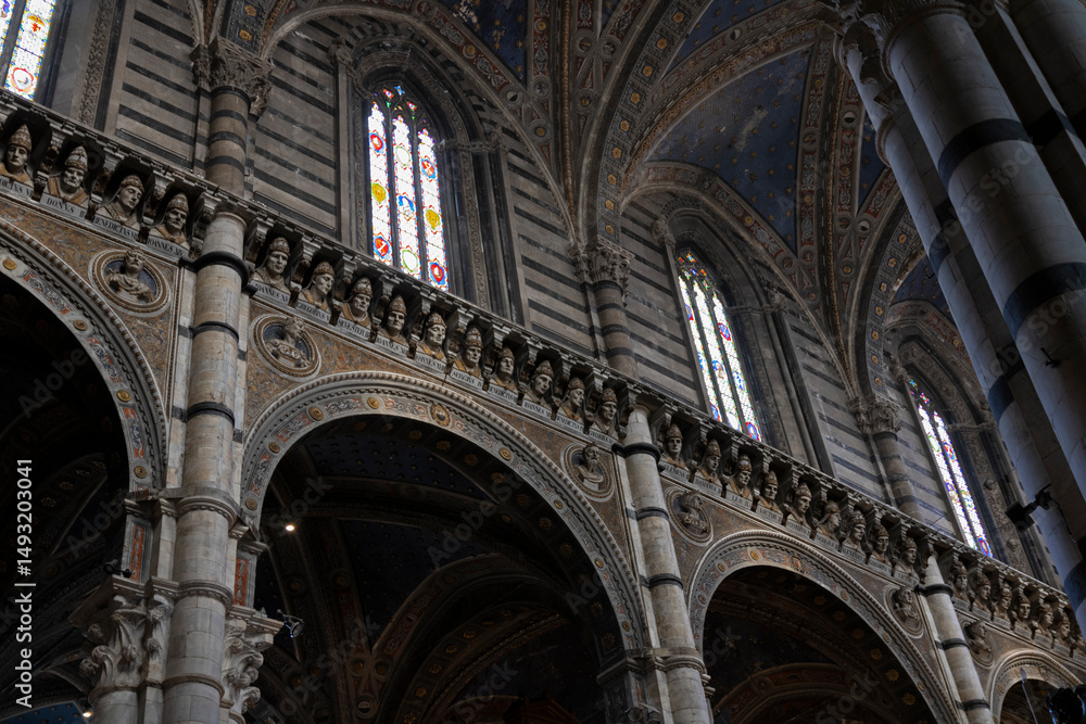 The interior of the Siena Cathedral (Duomo di Siena) with busts of popes and emperors. Italy. The interior of the Siena Cathedral (Duomo di Siena) with busts of popes and emperors. Italy.