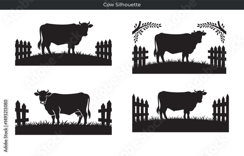 Elegant black cow silhouettes grazing in pasture fields behind farmhouse style wooden fences
