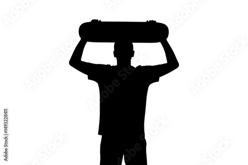 Silhouette of skateboarder holding skateboard above