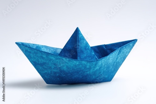 Wallpaper Mural A meticulously folded paper boat, crafted from textured blue paper, sits on a pristine white surface. Torontodigital.ca