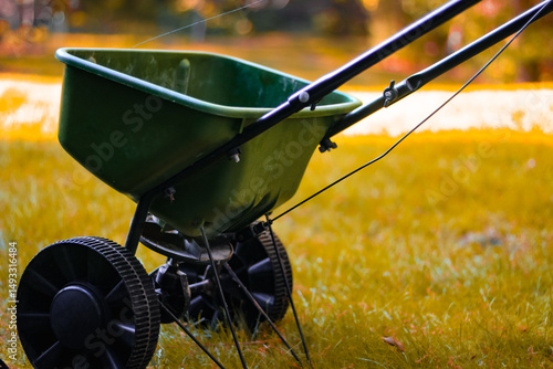 Tablou pe pânză Close-up of a broadcast seed or fertilizer spreader in a yard