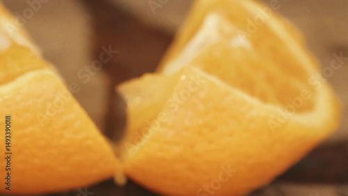 Senegalese Bartender Craft: Macro Close-up of African Hands Slicing Fresh Orange with Knife, Juice Dripping on Bar Counter for Cocktail Preparation