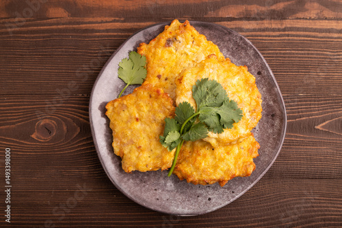 Fried crispy Chicken pancakes on brown wooden. top view, flat lay, close up