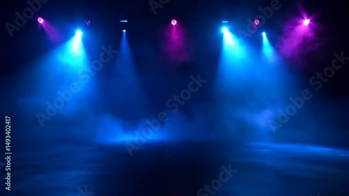 Light beams dance in vibrant colors illuminating a stage filled with mist during a captivating night of performance art