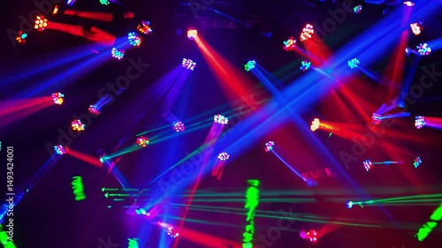Dynamic stage lighting with vibrant purple, blue, and red laser beams cutting through smoke, flashing and glowing. Abstract visual for concerts, club nights, music festivals, pop, and rock shows.