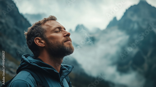 a man breathing deeply while surrounded by mountains and clean air