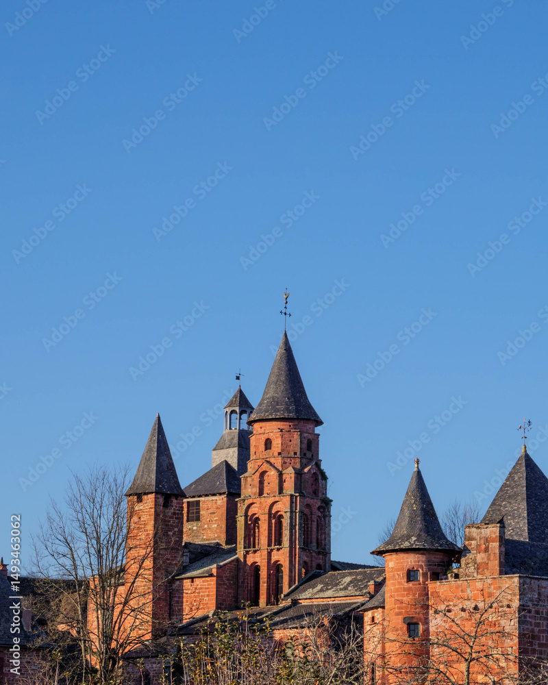 red stone turrets and bare trees in winter at collonges la rouge red stone turrets and bare trees in winter at collonges la rouge