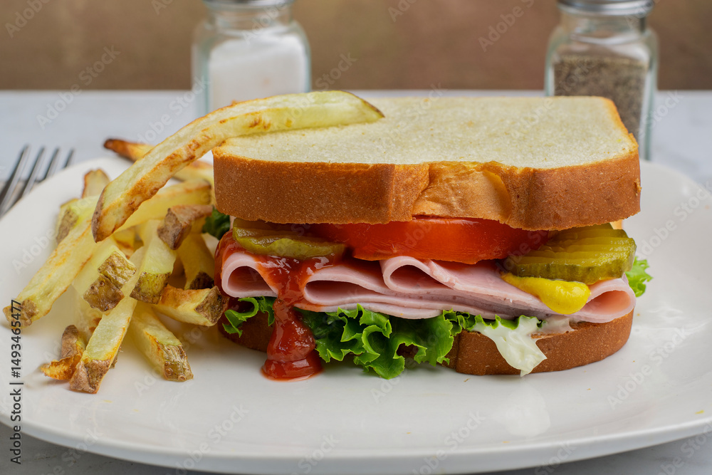 Obraz premium ham sandwich with a side of fries