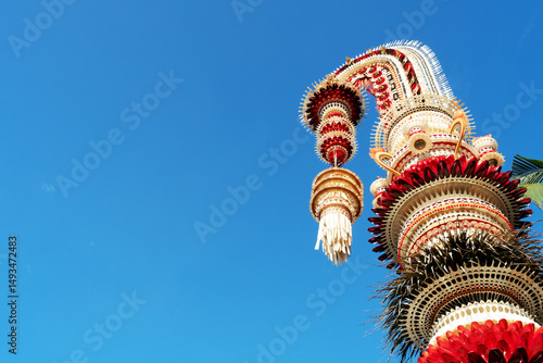 Balinese Penjor against blue sky Denpasar Bali