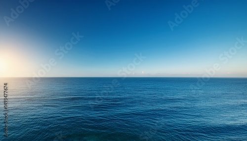 serene ocean view under a clear blue sky capturing tranquility and vastness at sunrise