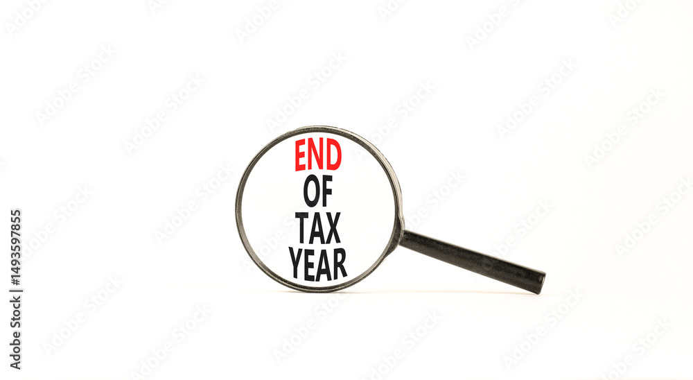 End of tax year symbol. Concept words phrase End of tax year in beautiful black magnifying glass. Beautiful white background. Business End of tax year concept. Copy space. End of tax year symbol. Concept words phrase End of tax year in beautiful black magnifying glass. Beautiful white background. Business End of tax year concept. Copy space.