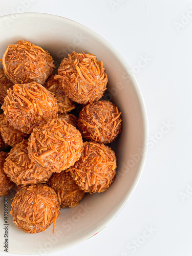 rounded brigadeiros covered with sugary brown burnt coconut