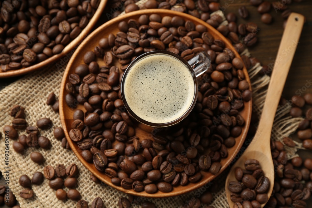 Fototapeta premium Aromatic coffee in cup and beans on table, flat lay