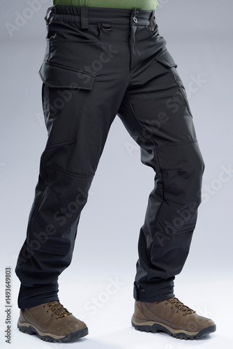 Принти на полотні Detailed view of black cargo-style tactical pants displayed with sturdy brown outdoor boots