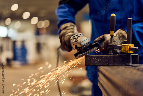 Worker Using Angle Grinder to Cut Metal with Sparks Flying