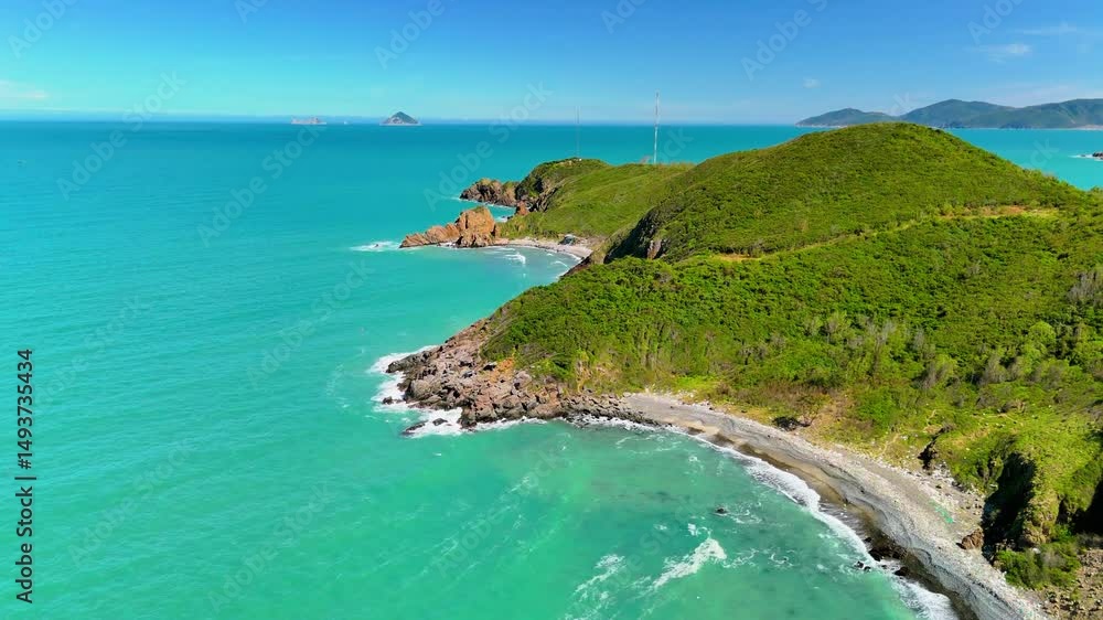 Aerial view Bright blue waters meet lush green hills in Nha Trang, Vietnam. Visitors can enjoy the scenic views as they explore the coastline, revealing nature's tranquility and adventure. Aerial view Bright blue waters meet lush green hills in Nha Trang, Vietnam. Visitors can enjoy the scenic views as they explore the coastline, revealing nature's tranquility and adventure.