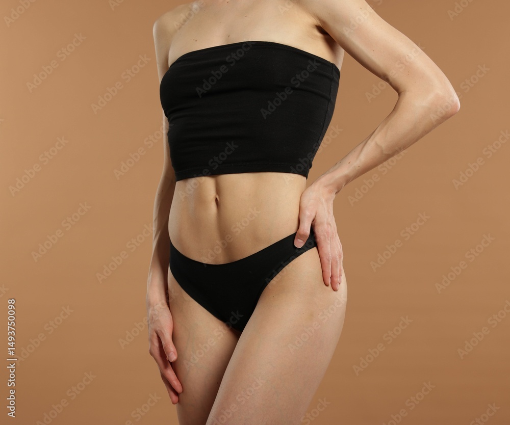 Fototapeta premium Woman with perfect slim body on beige background, closeup