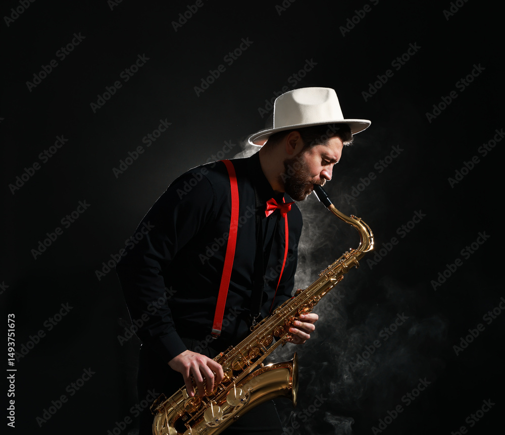 Naklejka premium Professional musician playing saxophone on black background with smoke