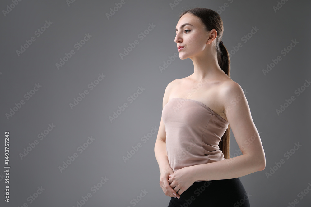 Obraz premium Portrait of beautiful woman on grey background. Space for text