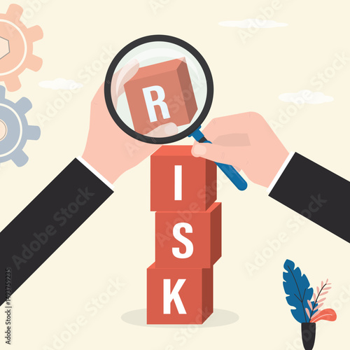 Analyze potential danger level. Hands with magnifying glass and cubes on stack with the word RISK. Risk management, control or assess to lose money in investing.