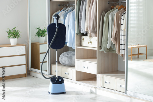Quadro su tela Modern upright steamer with stand near wardrobe indoors