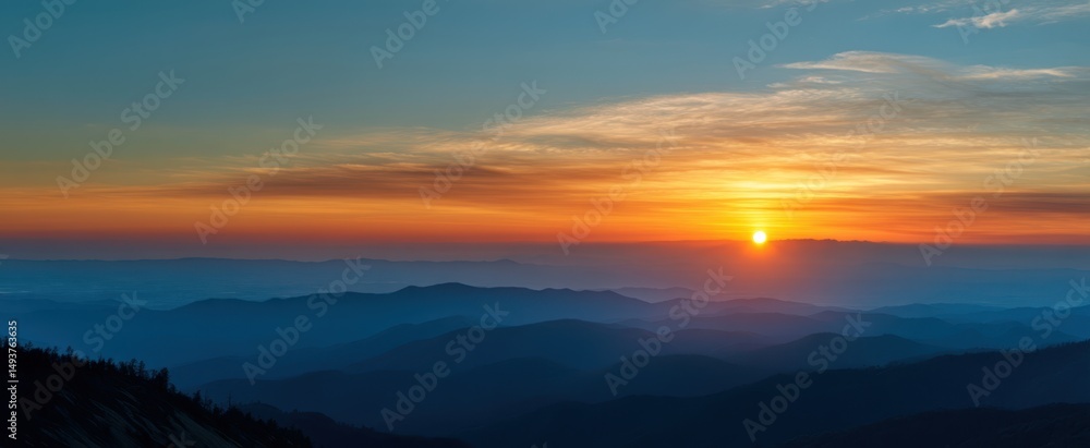 Fototapeta premium The breathtaking sunset over distant mountains creating a serene landscape view.