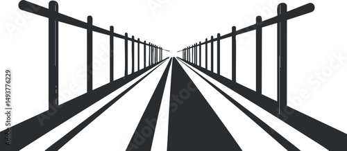 Black and white image of a straight road with fences on both sides creating strong perspective lines