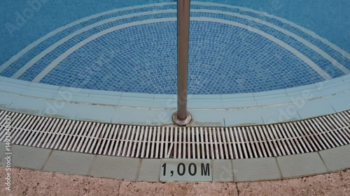 A pool with a green sign that says 1,100 meters