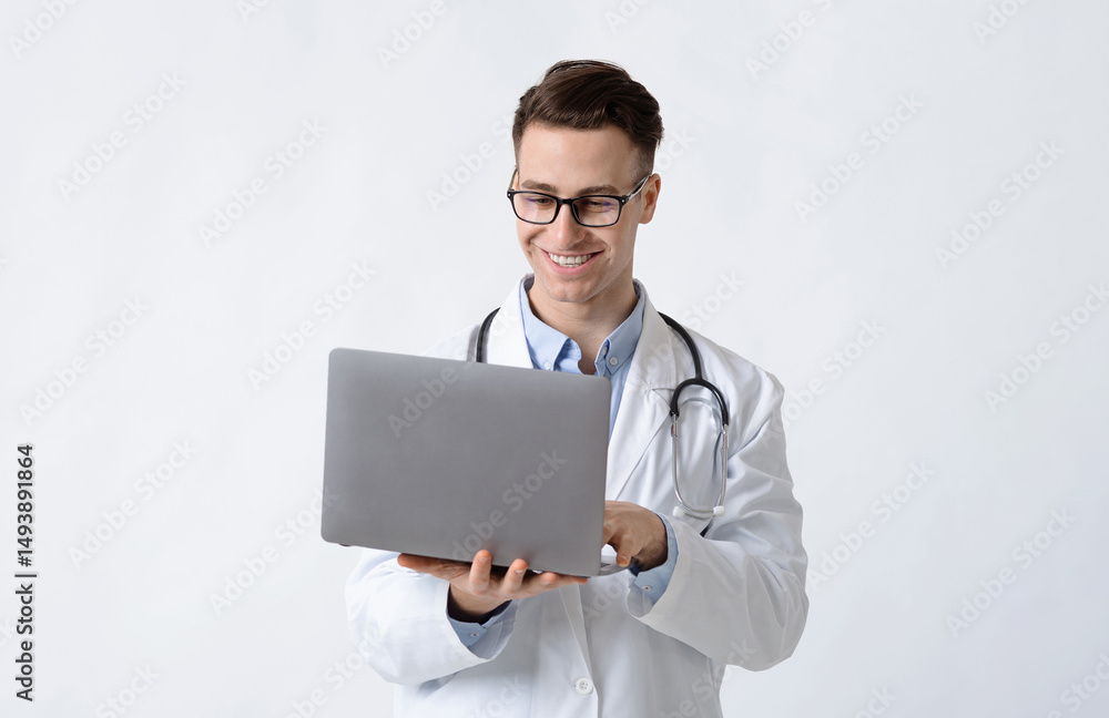 Smiling doctor in glasses and laptop in hands on white background Smiling doctor in glasses and laptop in hands on white background