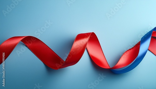 a wavy ribbon in red and blue against a light blue background creating a dynamic and playful visual effect