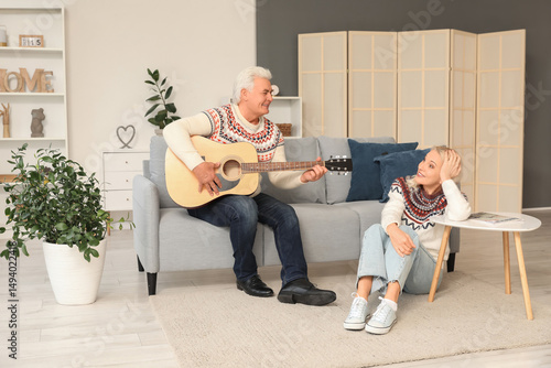 Mature man playing guitar w...