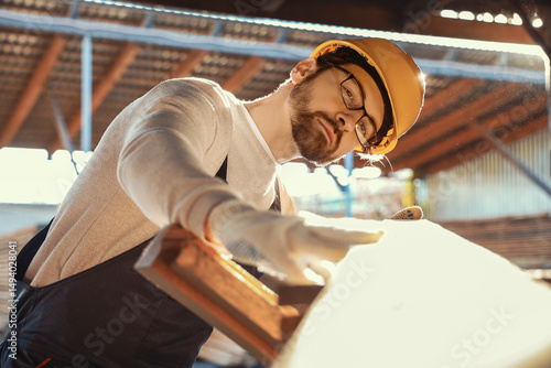 Male carpenter with wooden ...