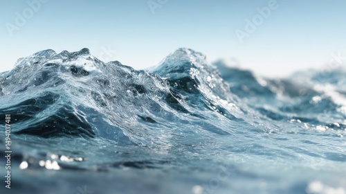 Fototapeta Naklejka Na Ścianę i Meble -  Close-up view of ocean wave cresting and breaking in clear blue water on a sunny day, surface level perspective, abstract nature scene