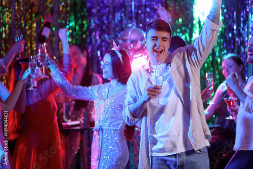 Young man with champagne at...