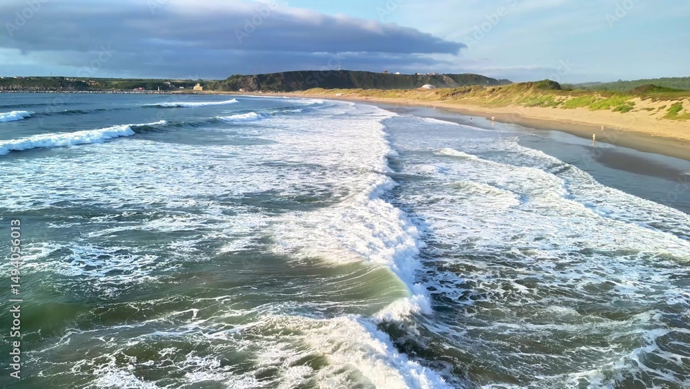 Fototapeta premium Experience the breathtaking beauty of scenic ocean waves at a picturesque coastal beach view